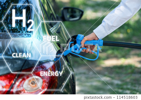 Man holds a hydrogen fueling nozzle. Refueling car with hydrogen fuel. Concept 114518603