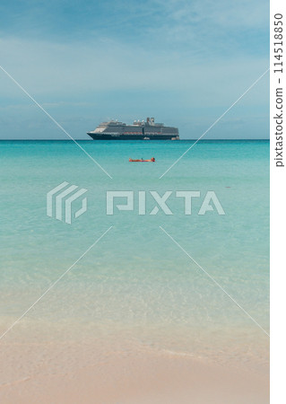 Man enjoing lounging on the ocean at Half moon cay Bahamas private island Caribbean 114518850