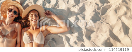 Two happy women lying on the beach in summer 114519119