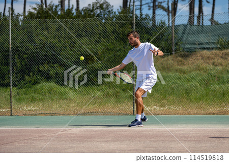 Tennis player hitting forehand at ball 114519818