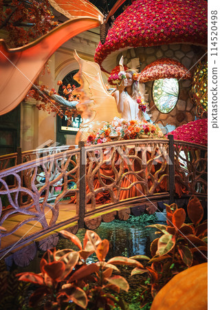 Elaborate indoor display in themed hotel on Las Vegas Strip. Vibrant colors, fairy statue with floral headpiece and wings. Enchanted forest scene over water. Rich details and artistry. Elaborate indoor display in themed hotel on Las Vegas Strip. Vibrant colors, fairy statue with floral headpiece and wings. Enchanted forest scene over water. Rich details and artistry. 114520498