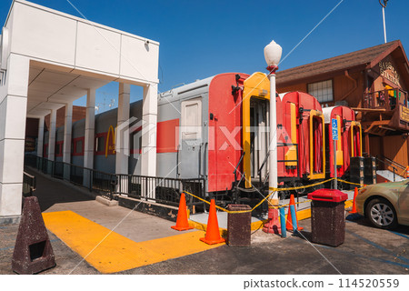 Vintage gas pumps with mid century design in Barstow, along Route 66. White facade building, wooden structure, clear desert sky. Nostalgic Americana scene. Vintage gas pumps with mid century design in Barstow, along Route 66. White facade building, wooden structure, clear desert sky. Nostalgic Americana scene. 114520559