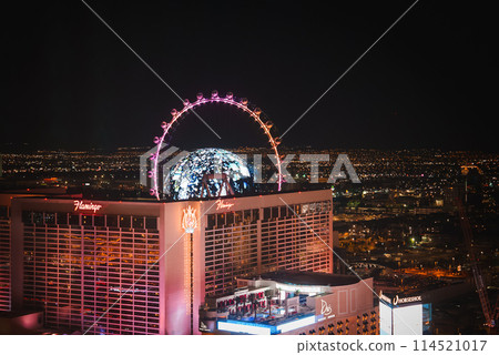 Vibrant night scene of Las Vegas Strip with Flamingo Hotel, Drai's nightclub, High Roller Ferris wheel, and city lights, showcasing energy and excitement of city nightlife. Vibrant night scene of Las Vegas Strip with Flamingo Hotel, Drai's nightclub, High Roller Ferris wheel, and city lights, showcasing energy and excitement of city nightlife. 114521017