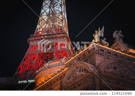 Close up view of a red lit Eiffel Tower replica at Paris Las Vegas Hotel and Casino on the Las Vegas Strip. Iconic landmarks and vibrant nightlife captured beautifully. Close up view of a red lit Eiffel Tower replica at Paris Las Vegas Hotel and Casino on the Las Vegas Strip. Iconic landmarks and vibrant nightlife captured beautifully. 114521090