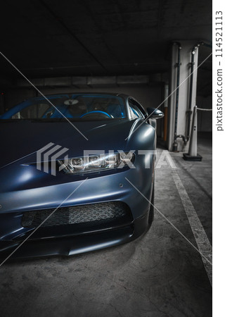 Luxury Bugatti Chiron in metallic blue in underground garage. Sleek design with carbon fiber details, modern LED headlights. Possibly in high end LA location. Luxury Bugatti Chiron in metallic blue in underground garage. Sleek design with carbon fiber details, modern LED headlights. Possibly in high end LA location. 114521113