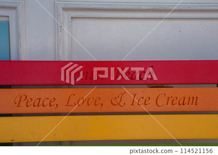 Colorful wooden slats with Venice Beach vibes. Red slat says Venice Beach, orange reads Peace, Love, and Ice Cream, yellow slat blank. Playful and laid back aesthetic. 114521156