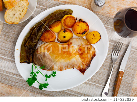 Toasted piece of pork tenderloin with fried potatoes and baked bell pepper. Toasted piece of pork tenderloin with fried potatoes and baked bell pepper. 114522829
