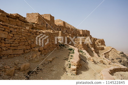 Ancient stone houses and on the mountain slopes in Guermassa region. South Tunisia. Tatouine governorate,Tunisia 114522845