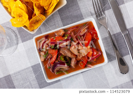 Ceviche served with fried banana in bowl 114523079