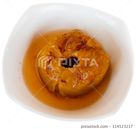 Delicious baked apple served with caramel sauce on plate 114523217
