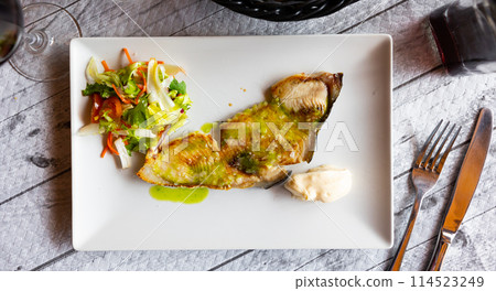 Tasty fish Marrajo shark and vegetables salad with sauce at plate. Spanish traditional dish 114523249
