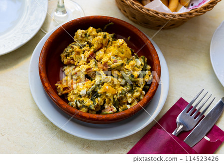 Scrambled eggs served with ham for breakfast 114523426