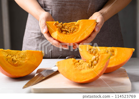 Orange Hokkaido pumpkin with hand prepare for cooking Orange Hokkaido pumpkin with hand prepare for cooking 114523769