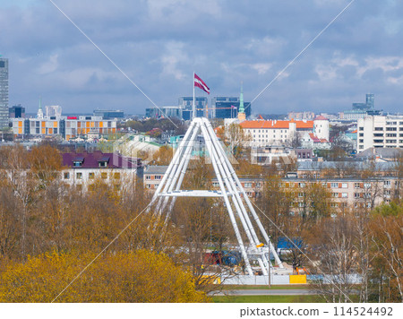 Construction of the observation wheel in Riga, Latvia. Beautiful ferris wheel in the Victory park in the center of Riga with a beautiful view of the old town. 114524492