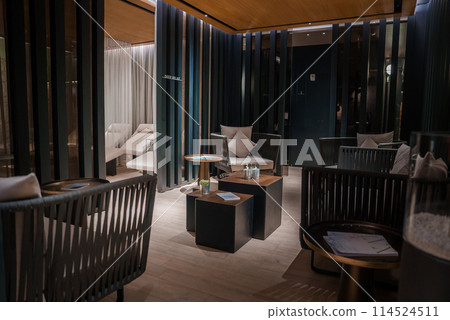 Luxury hotel room in Zermatt, Switzerland with modern design, plush furniture, dim lighting, and cozy ambiance. Chic and inviting space for relaxation. 114524511