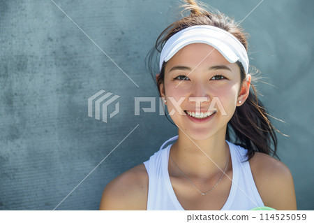 A woman wearing sportswear who enjoys tennis 114525059
