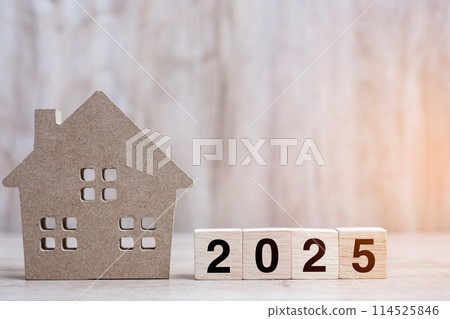 2025 Happy New Year with house model on table wooden background. Banking, real estate, investment, financial, savings and New Year Resolution concepts 114525846