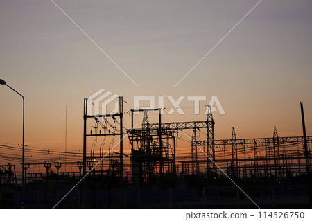 Silhouetted high-voltage electric tower in the dramatic sunset sky Silhouetted high-voltage electric tower in the dramatic sunset sky 114526750