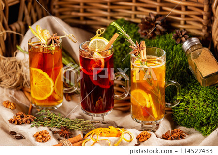 Closeup glasses of herbal tea with lemon at decorated with forest moss and sack cloth background. Closeup glasses of herbal tea with lemon at decorated with forest moss and sack cloth background. 114527433