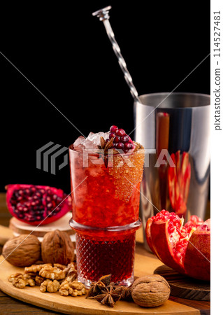 Verical image of glass of homemade pomegranate lemonade at decorated wooden table background. 114527481