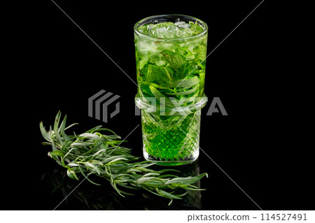 Glass of lemonade with cucumber, lime and stragon and a branch of rosemary isolated at black background. 114527491