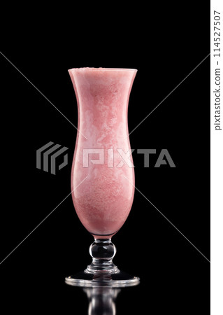 Glass of fresh pink strawberry milkshake isolated at black background. 114527507
