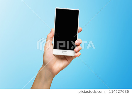 Mockup of female hand holding frameless cell phone with black screen isolated at blue background. 114527686