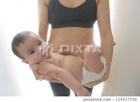 A woman's belly with stretch marks after giving birth and a smiling half-Japanese baby boy being held in his arms A woman's belly with stretch marks after giving birth and a smiling half-Japanese baby boy being held in his arms 114527730