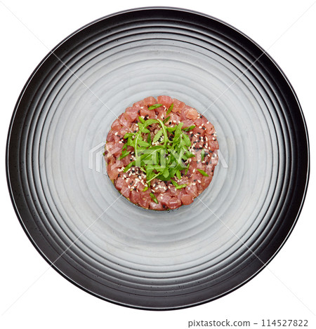 Tuna and avocado tartare on a dark ceramic plate 114527822