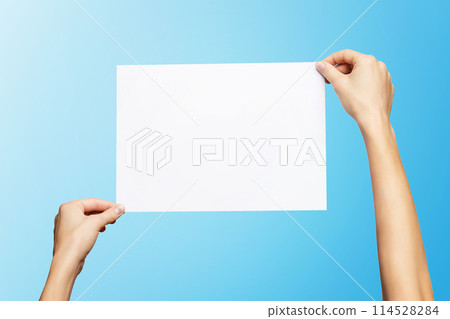 Mockup of female hands holding blank paper list isolated at blue background. 114528284