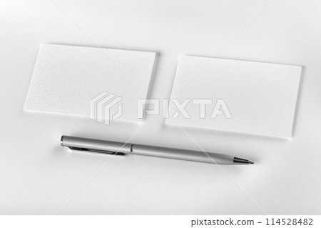 Mockup of two horizontal business cards and pen at white textured background. 114528482