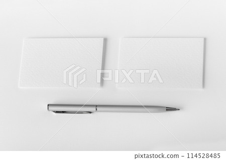 Mockup of two horizontal business cards and pen at white textured background. 114528485