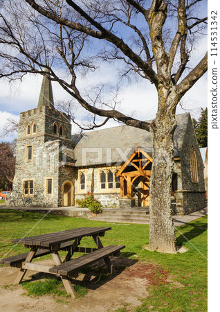 Stone church and garden bench in Queenstown 114531342