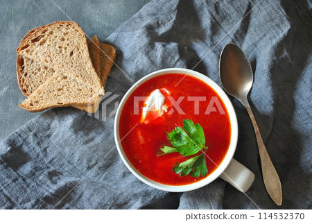 Traditional Ukrainian Russian borscht . Bowl of red beet root soup borsch with white cream on gray rustic background. Beet Root soup top view. Traditional Ukrainian food cuisine 114532370