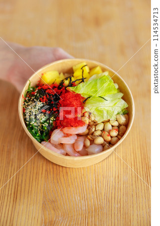 Hawaiian shrimp poke bowl with seaweed, avocado, mango, radish, sesame seeds. Top view, overhead, flat lay, copy space 114534713