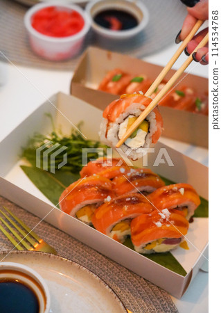 Sushi roll Philadelphia with salmon, smoked eel, avocado, cream cheese on black background. Sushi menu. Japanese food. 114534768