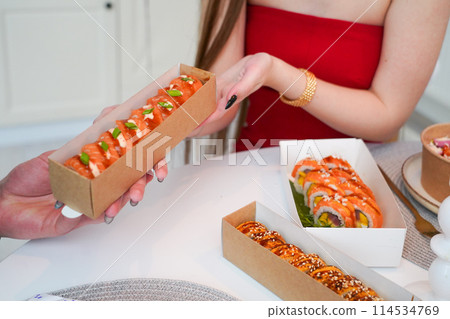 Sushi roll Philadelphia with salmon, smoked eel, avocado, cream cheese on black background. Sushi menu. Japanese food. Sushi roll Philadelphia with salmon, smoked eel, avocado, cream cheese on black background. Sushi menu. Japanese food. 114534769