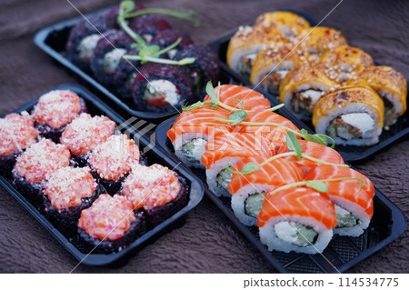 Sushi roll Philadelphia with salmon, smoked eel, avocado, cream cheese on black background. Sushi menu. Japanese food. 114534775