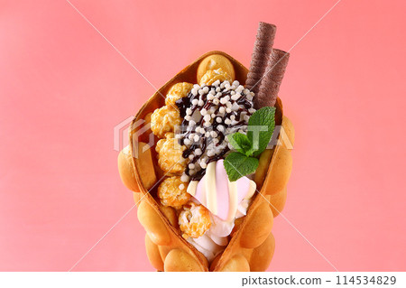 Hong kong or bubble waffle with ice cream, chocolate sauce and isolated on white background Hong kong or bubble waffle with ice cream, chocolate sauce and isolated on white background 114534829