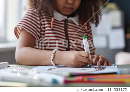 Close up of unrecognizable African American girl drawing picture at home, copy space 114535175