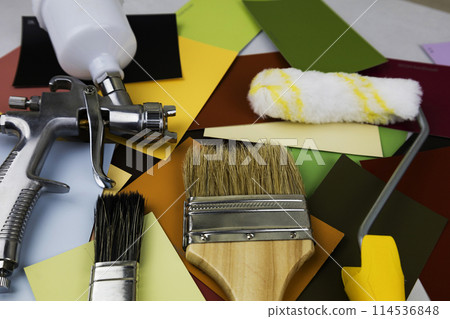 Paint spray gun at work at the workplace in the workshop. Paint Brush 114536848