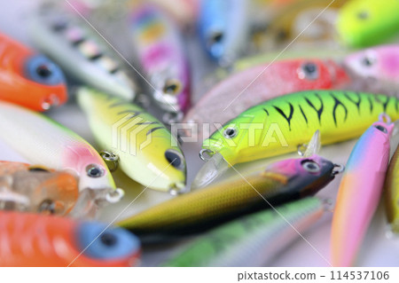 Pinpoint focus close-up image of a collection of minnow lures for fishing 114537106