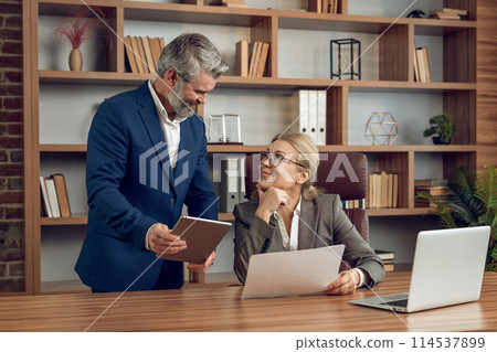 Confident man and woman discussing on psychological assistance using laptop 114537899