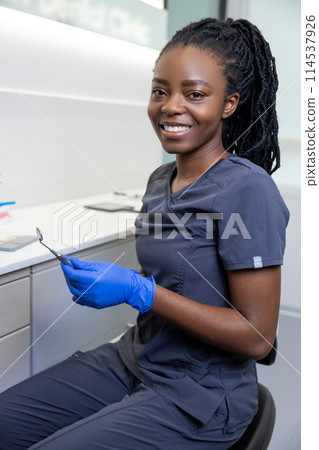 Young smiling african american female dentist at her office Young smiling african american female dentist at her office 114537926