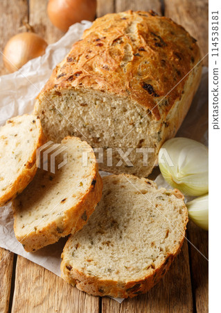 Rustic traditional onion bread closeup on the wooden board. Vertical 114538181