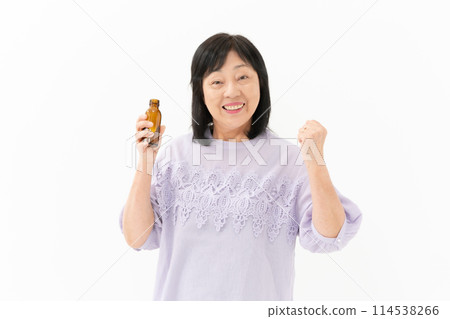 Senior woman, energy drink, fist pump Senior woman, energy drink, fist pump 114538266