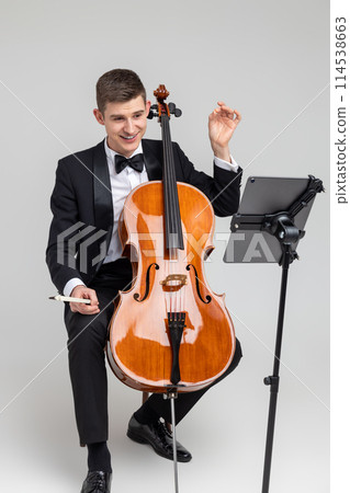 Man musician performing with cello and music note 114538663