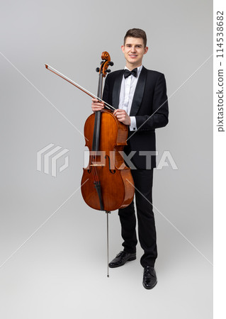 Man artist wearing tuxedo playing contrabass Man artist wearing tuxedo playing contrabass 114538682