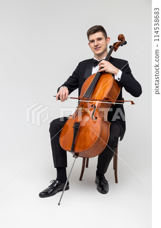 Man artist wearing tuxedo playing contrabass 114538683