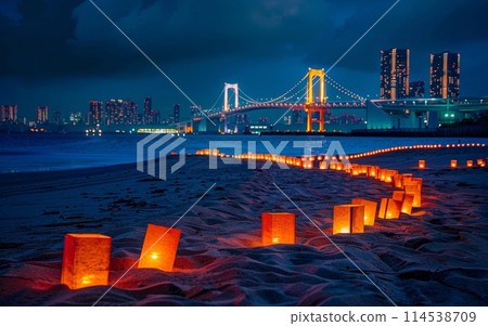 A serene beach setting at dusk, illuminated by a string of candles leading towards a brightly lit suspension bridge and city skyline. Japanese Marine Day Umi no Hi also known as Ocean Day or Sea Day 114538709